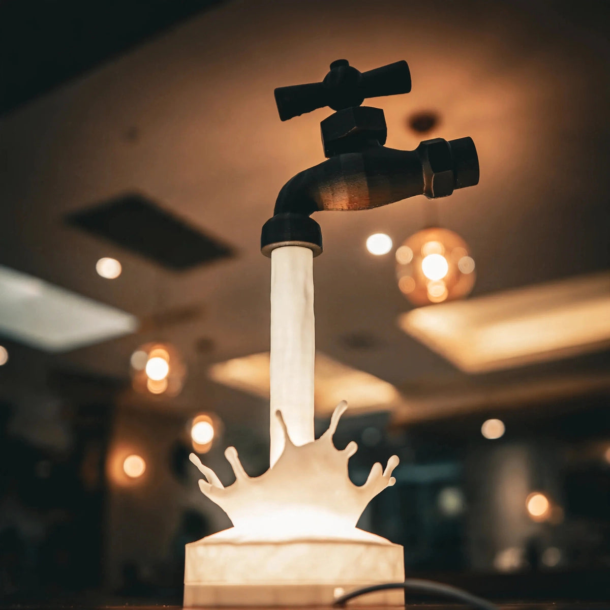Floating faucet lamp pouring a glowing stream of light — photo 8